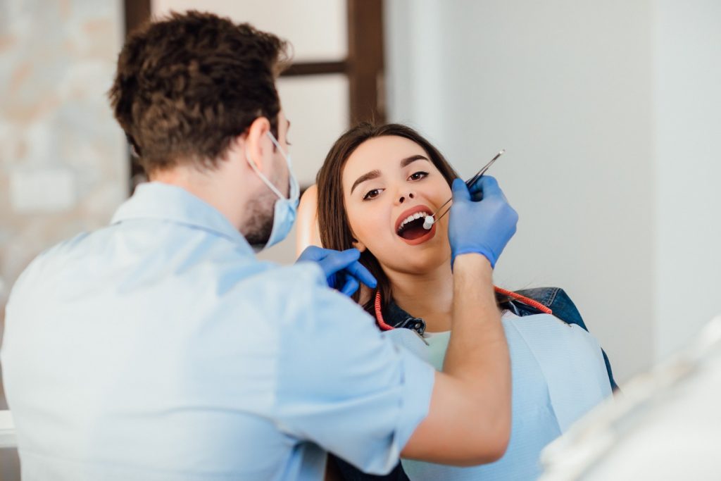 Dentist Examining Patient Teeth